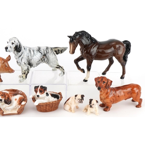 1058 - Royal Doulton animals including seated Bulldogs, pigs and a Setter dog, the largest 21cm in length