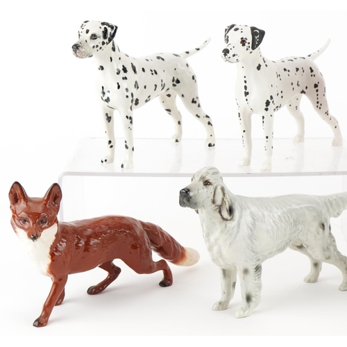 1057 - Six Beswick dogs and a Beswick fox including St Bernard's, Arnoldene and Jack Russell Terrier, the l... 