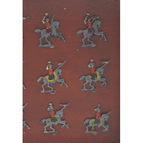 554 - Wooden cased hand painted flat lead soldiers on horseback, 33cm x 24cm