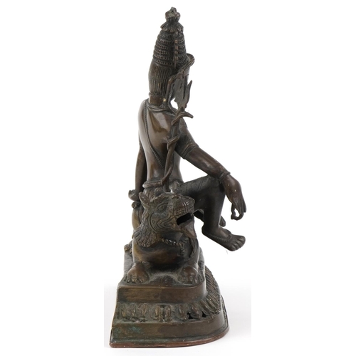 79 - Chino Tibetan bronze Buddha of Tara seated on a lion, 24cm high