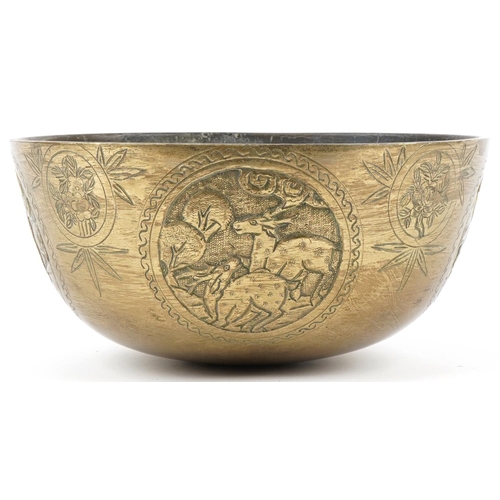 Large Chinese bronze singing bowl decorated with panels of dogs of Foo, flowers and deer, character mark to the base, 26cm in diameter