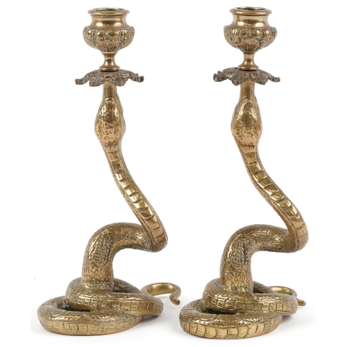 128 - Pair of Indian brass snake candlesticks, 23cm high