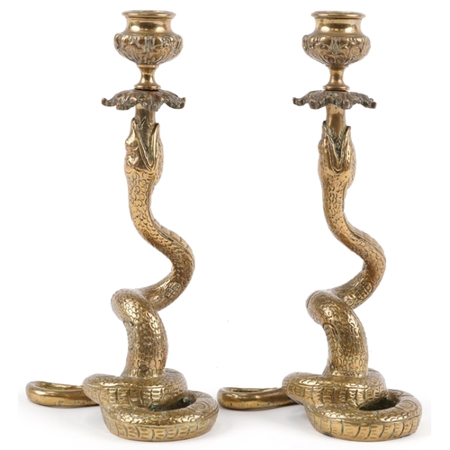 128 - Pair of Indian brass snake candlesticks, 23cm high