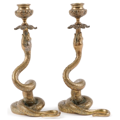 128 - Pair of Indian brass snake candlesticks, 23cm high