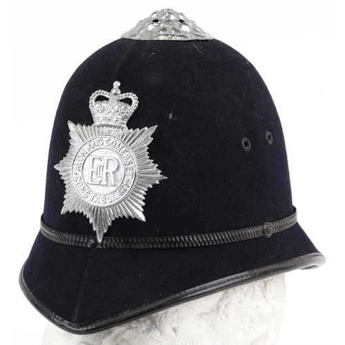 1337A - Avon & Somerset Constabulary policeman's helmet with two badges and cloth patch