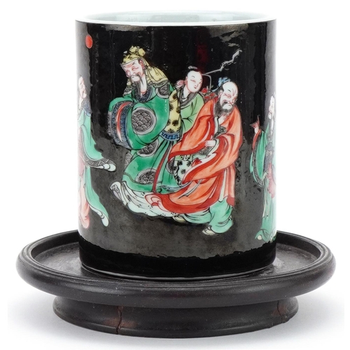 73 - Chinese porcelain brush pot decorated with elders mounted on a wooden stand, 12cm high