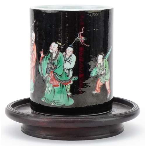 73 - Chinese porcelain brush pot decorated with elders mounted on a wooden stand, 12cm high