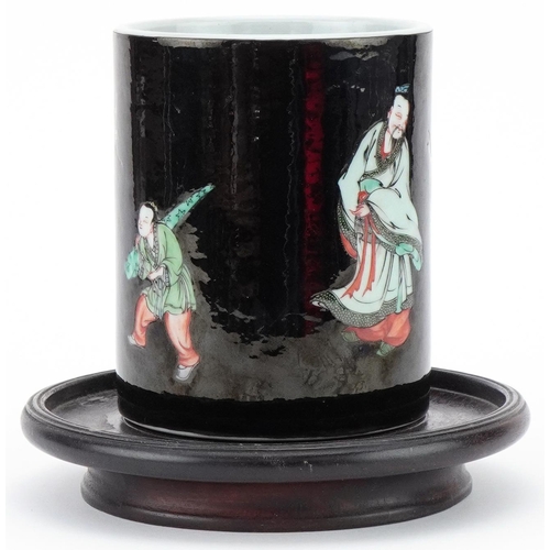 73 - Chinese porcelain brush pot decorated with elders mounted on a wooden stand, 12cm high