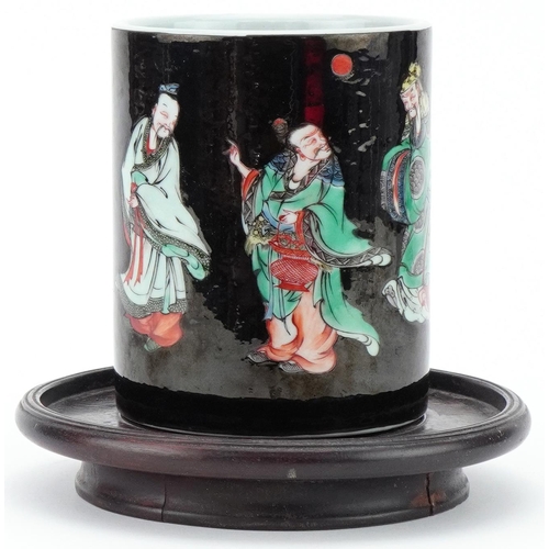 73 - Chinese porcelain brush pot decorated with elders mounted on a wooden stand, 12cm high