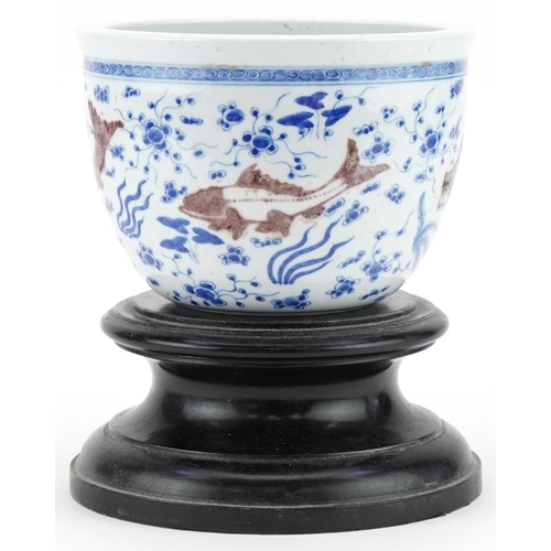 285 - Chinese porcelain jardinière decorated with fish, mounted on a wooden stand, character mark to the b... 