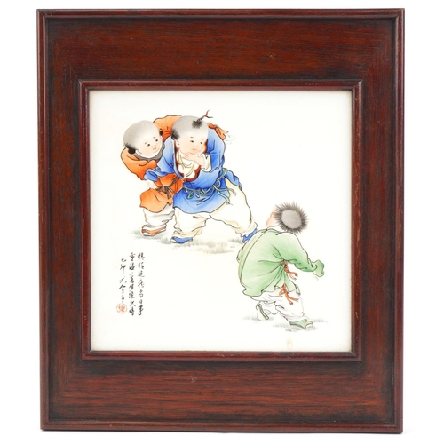 356 - Chinese porcelain panel with children and script, mounted in a hardwood frame together with a black ... 