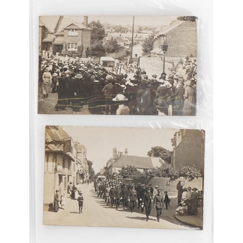 Album of postcards, some photographic, including Devil's Dyke, Brighton, sweetheart cards including an airship, street scenes including World War I soldiers marching with Red Cross ambulance Eastbourne, and Kent Road Halling corner shop, approximately eighty cards