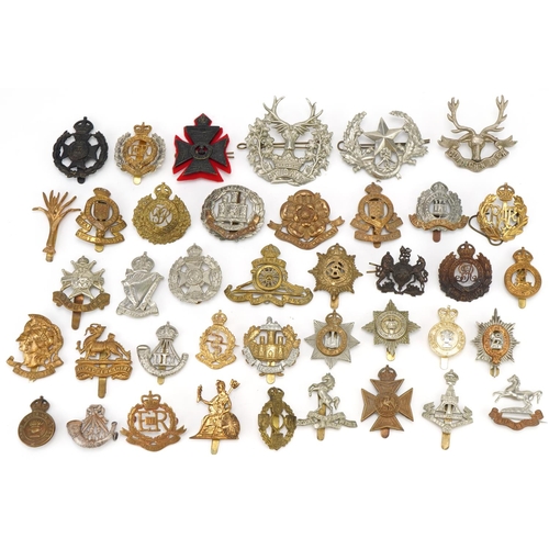 1518 - Approximately forty military cap badges, to include Royal Berkshire Regiment, Lancashire Hussars and... 