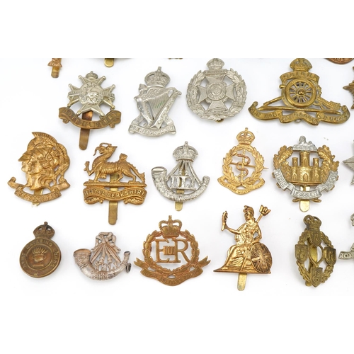 1518 - Approximately forty military cap badges, to include Royal Berkshire Regiment, Lancashire Hussars and... 