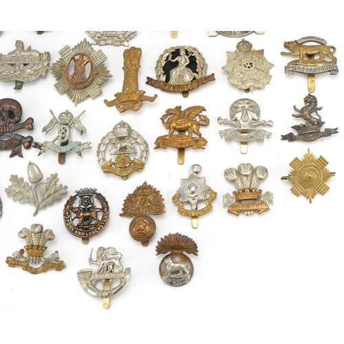 1520 - Approximately forty cap badges to include Highland Regiment, Scottish King's Borderers, The Royal Sc... 