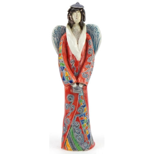 Hand sculptured and hand painted abstract pottery angel, signature to the side, 25cm high