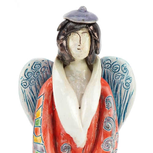 1047 - Hand sculptured and hand painted abstract pottery angel, signature to the side, 25cm high