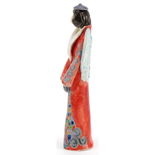 1047 - Hand sculptured and hand painted abstract pottery angel, signature to the side, 25cm high