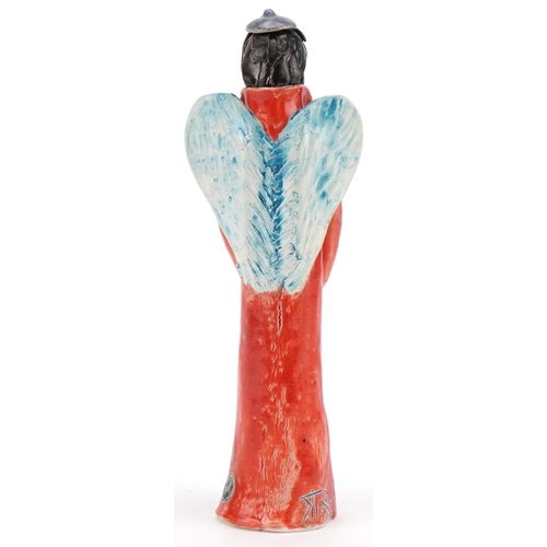 1047 - Hand sculptured and hand painted abstract pottery angel, signature to the side, 25cm high