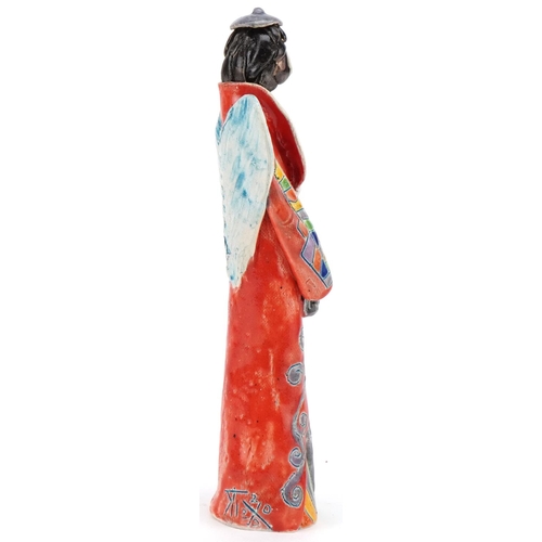 1047 - Hand sculptured and hand painted abstract pottery angel, signature to the side, 25cm high