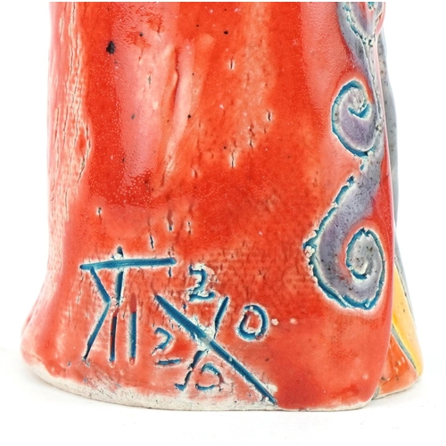 1047 - Hand sculptured and hand painted abstract pottery angel, signature to the side, 25cm high