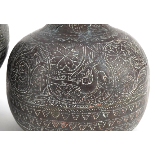 223 - Two Middle Eastern Islamic brass vases, one decorated with birds and flowers, the largest 18cm high