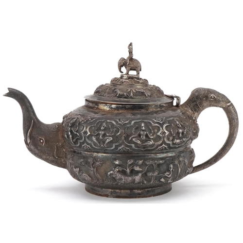 117 - Indian unmarked silver teapot with elephant head handle and spout profusely embosses with wild anima... 