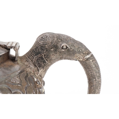 117 - Indian unmarked silver teapot with elephant head handle and spout profusely embosses with wild anima... 