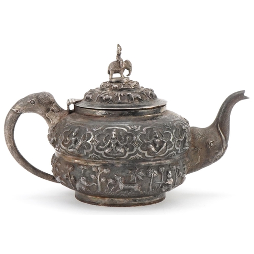 117 - Indian unmarked silver teapot with elephant head handle and spout profusely embosses with wild anima... 