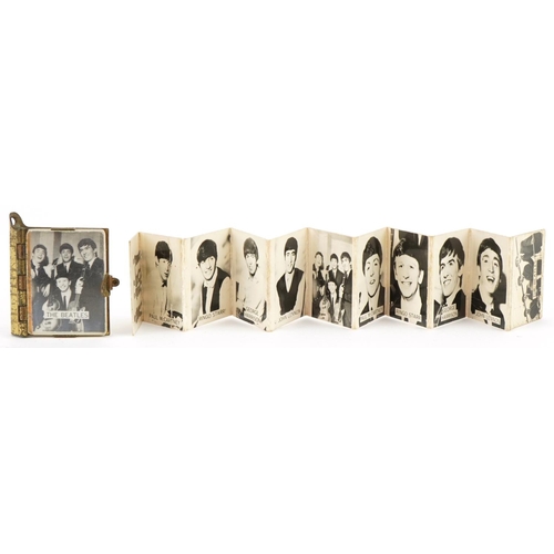 505 - The Beatles black and white photographic cards together with a small brass backed Beatles book, the ... 