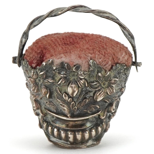 316 - Victorian unmarked silver pin cushion in the form of a basket with swing handle embossed with  flowe... 