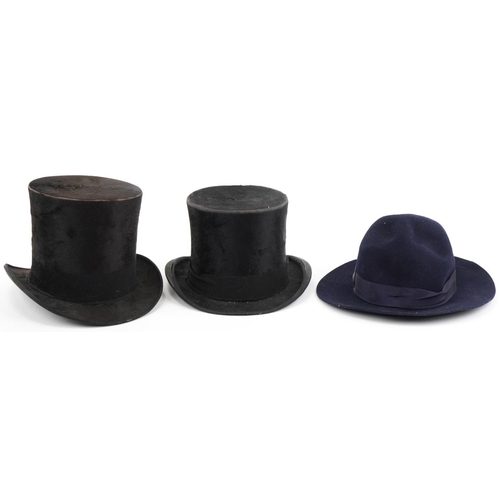 415 - Two gentlemen's moleskin top hats retailed by Dunn & Co and J Hefford together with one other hat re... 