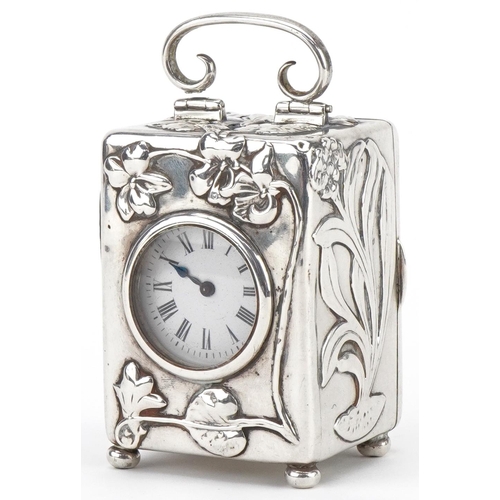 William Comyns & Sons, Art Nouveau silver carriage clock with swing handle embossed with stylised flowers, London 1901, 10.5cm high, total weight 384.0g