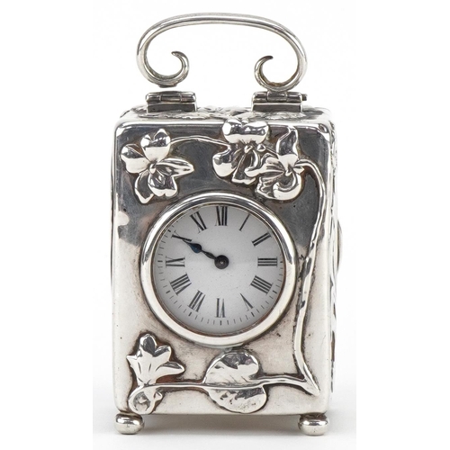 87 - William Comyns & Sons, Art Nouveau silver carriage clock with swing handle embossed with stylised fl... 