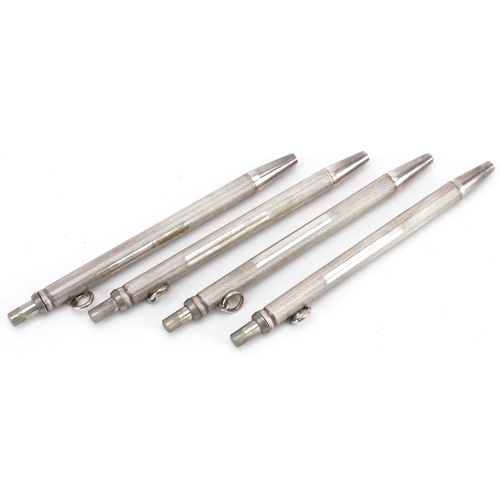 2438 - Set of four sterling silver engine turned bridge marker pens with fitted case, each 9cm high, total ... 