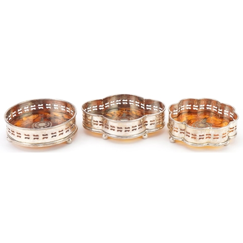 2462 - Three silver plated and faux tortoiseshell pique work design wine coasters, the largest 15.5cm wide