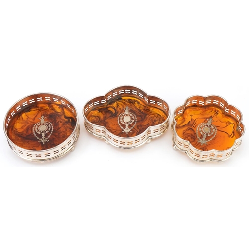 2462 - Three silver plated and faux tortoiseshell pique work design wine coasters, the largest 15.5cm wide