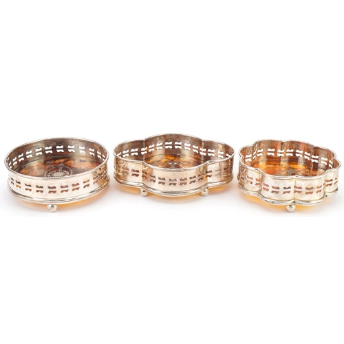 2462 - Three silver plated and faux tortoiseshell pique work design wine coasters, the largest 15.5cm wide