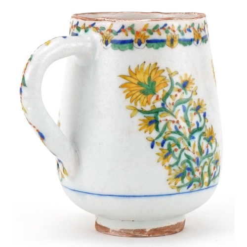 121 - Ottoman Turkish Kütahya wine cup hand painted with sprays of flowers, 13cm high