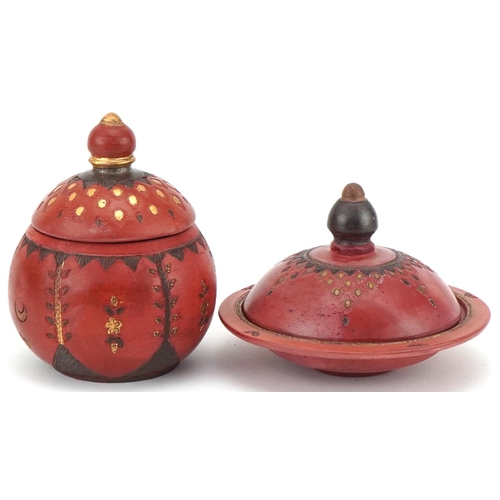 226 - Two Turkish Tophane pottery bowls and covers decorated with flowers, the largest 12cm high