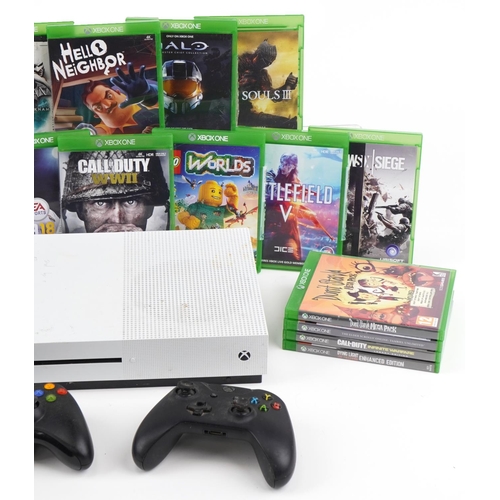 643 - Xbox One S games console with controllers and a collection of games