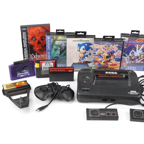 634 - Sega Master System II games console with controllers and a collection of games