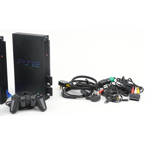 644 - Two Sony PlayStation 2 games consoles with controllers