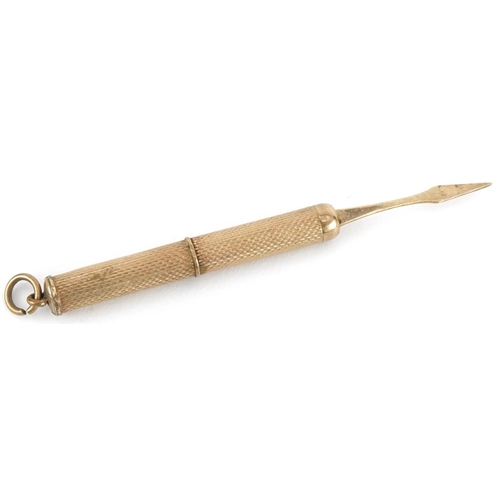 307 - 9ct gold propelling toothpick, 7cm in length when extended, 5.6g