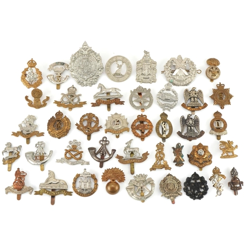 1519 - Approximately forty military cap badges to include Royal Warwickshire, Cornwall Light Infantry, Dors... 