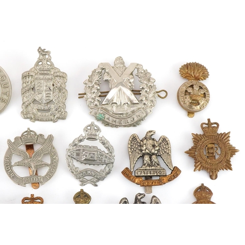 1519 - Approximately forty military cap badges to include Royal Warwickshire, Cornwall Light Infantry, Dors... 