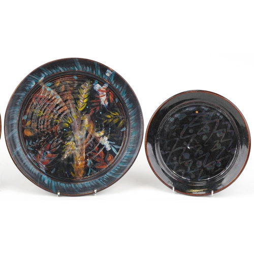 336 - R H three studio pottery plates hand painted with an abstract design impressed marks to back, the la... 