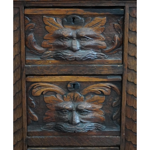 1003 - Victorian oak twin pedestal desk carved with a green man masks, fitted with an arrangement of nine d... 