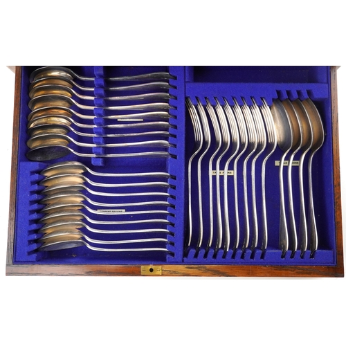 384 - Edwardian oak cased canteen of silver plated cutlery by Barker Brothers including a carving set