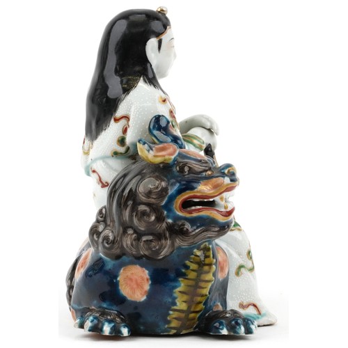 295 - Japanese Kutani porcelain figure of a female on mythical animal, 15.5cm wide